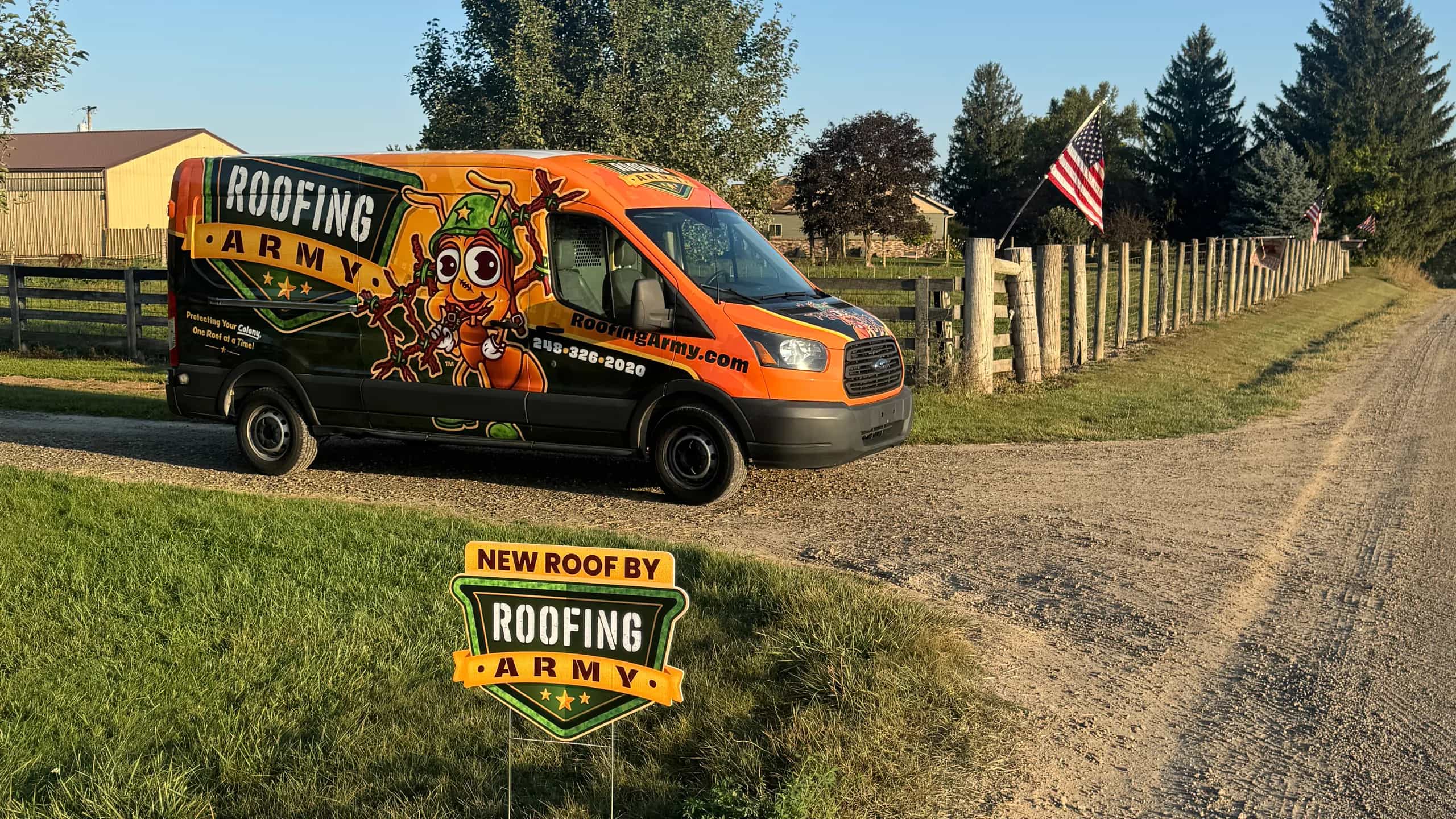 A Roofing Army van and yard sign outside a completed roof replacement in Southeast Michigan