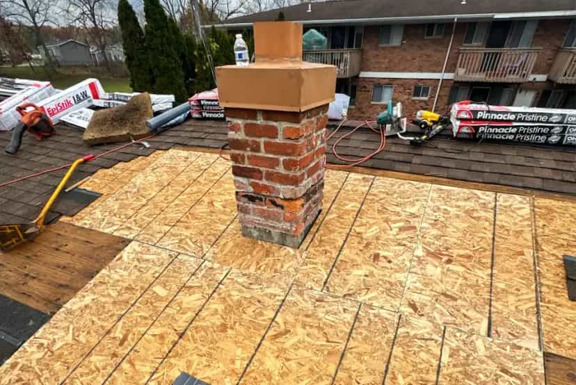 Roof Repair Services in Michigan - Roofing Army sheets of osb plywood around a brick chimney repair in michigan