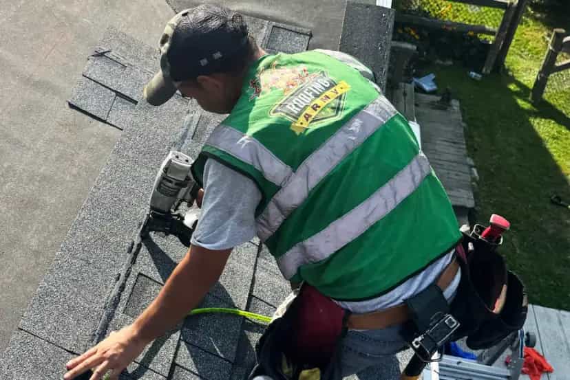 Roof Replacement Services in SE Michigan - Roofing Army a roofer nailing a shingle on a roof replacement job in michigan