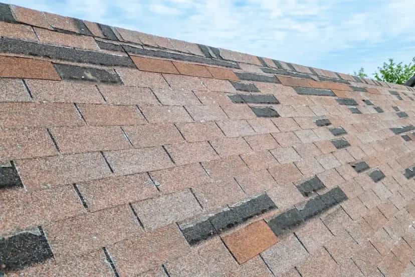 Storm Damage Services in SE Michigan - Roofing Army missing shingles on an asphalt roof in michigan from wind damage